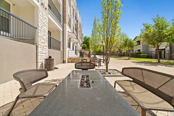 A view of a patio with a table and chairs.